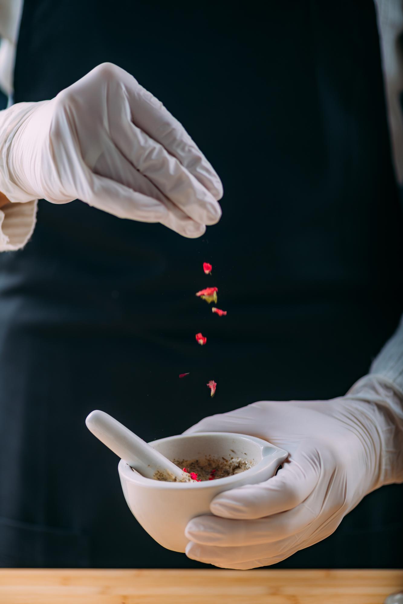Close-up of hands seasoning